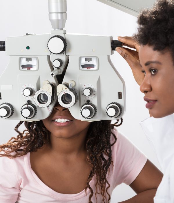 Female African Optometrist Doing Sight Testing For Patient In Hospital